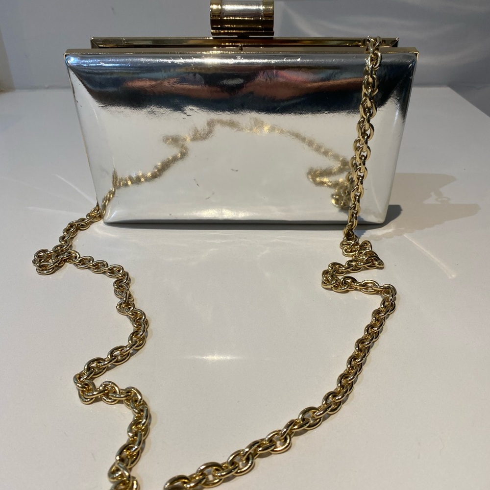 Small silver clutch with gold accents & chain
